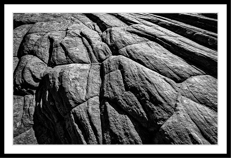 A large rock with lines and shadows.